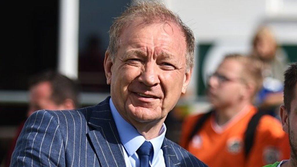 Truro City chairman Peter Masters watches on