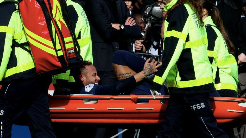 Neymar is carried off on a stretcher during PSG's match with Lille