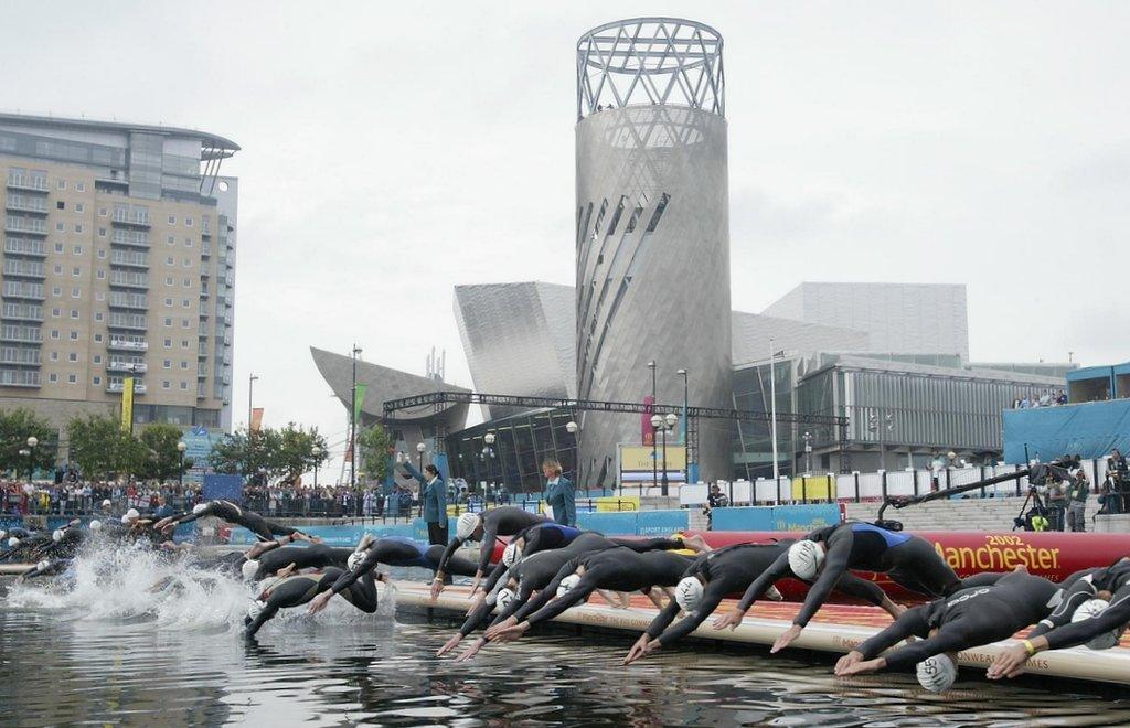 swimmers dive in outside the Lowry Theatre