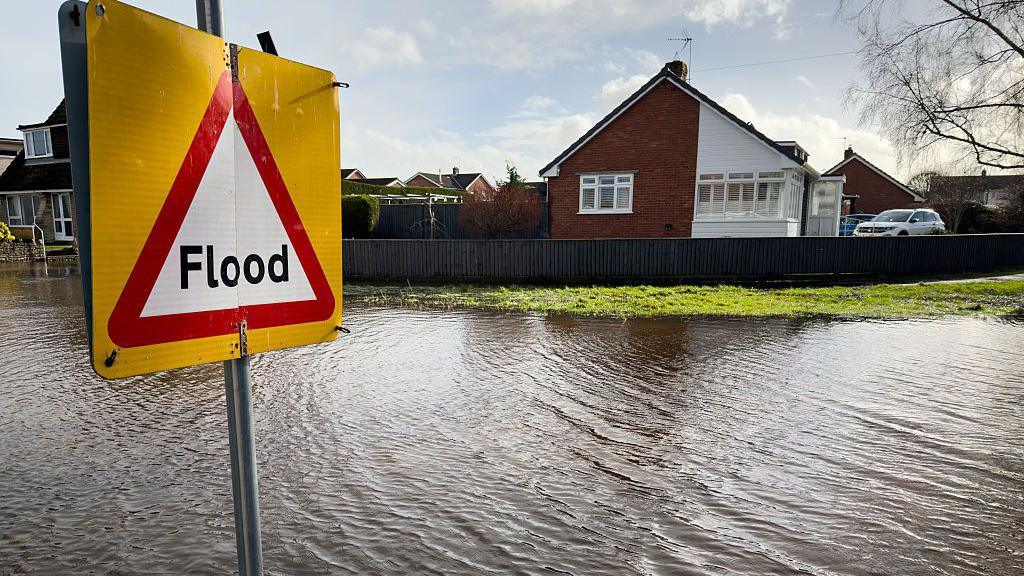 A flooding near a house with lots of flooding nearby