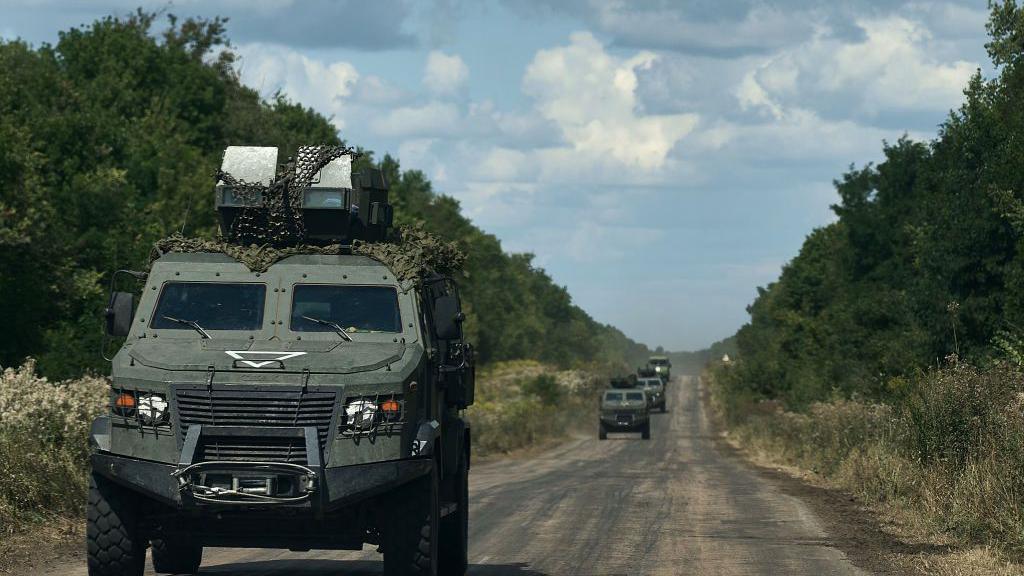 A Ukrainian armoured infantry vehicle travels on the road from Sumy to the border with Russia