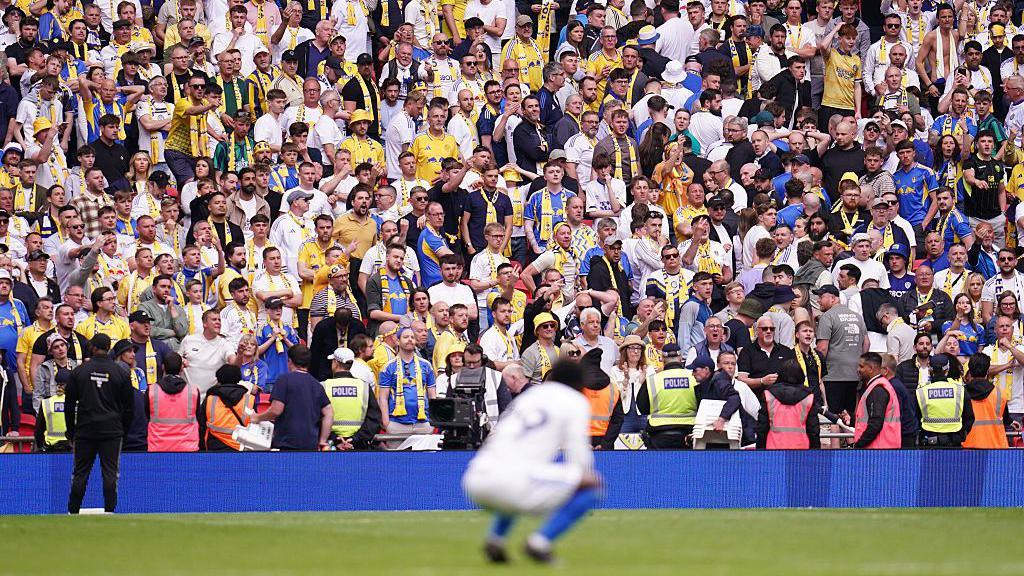 Leeds fans at full time as Wilfried Gnonto of Leeds United looks on