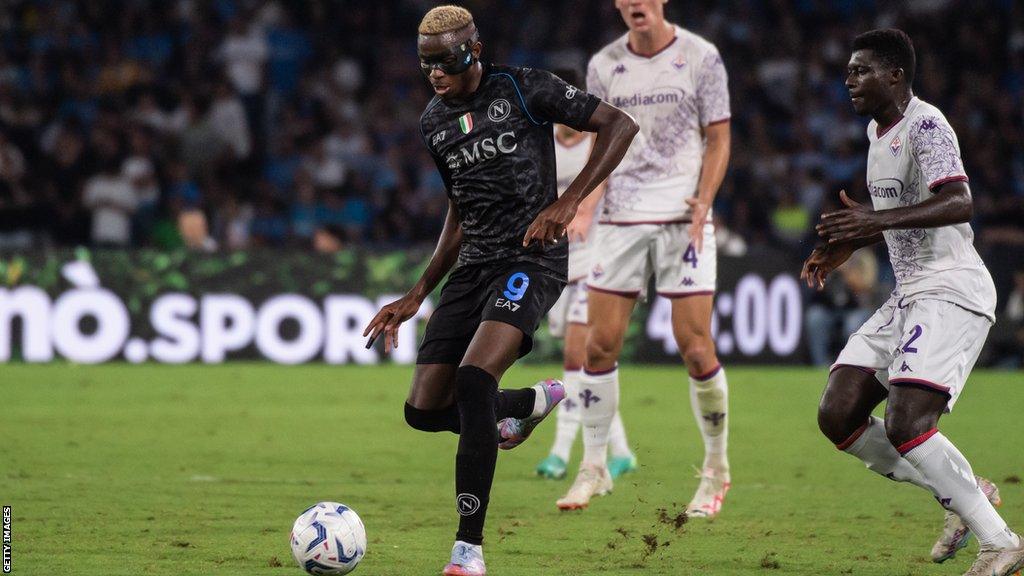 Victor Osimhen passes the ball playing for Napoli