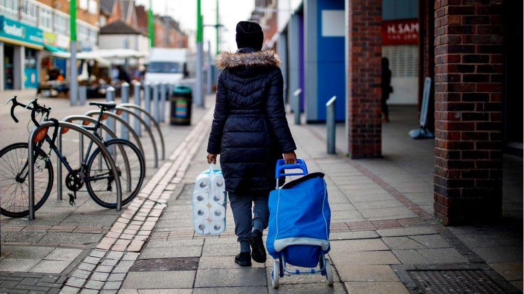 Shopper with toilet rolls