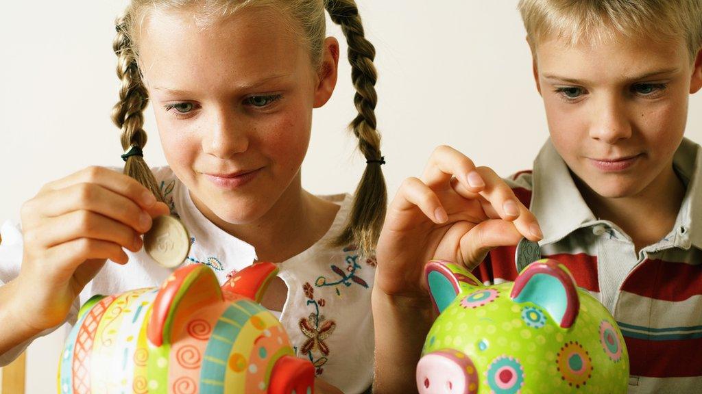 Girl and boy with piggy banks