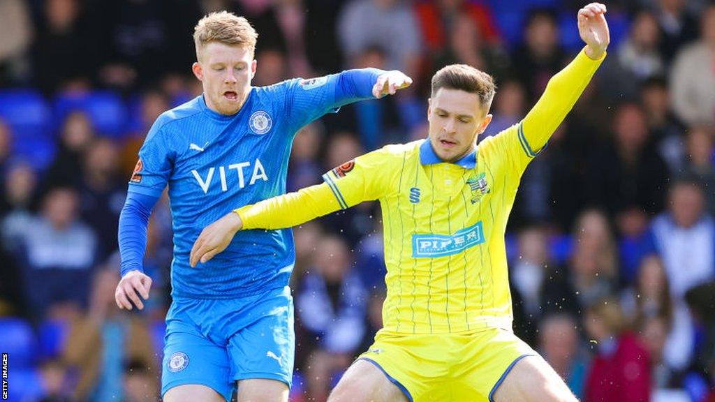 Andy Cannon of Stockport County battles for possession with Ryan Barnett of Solihull Moors