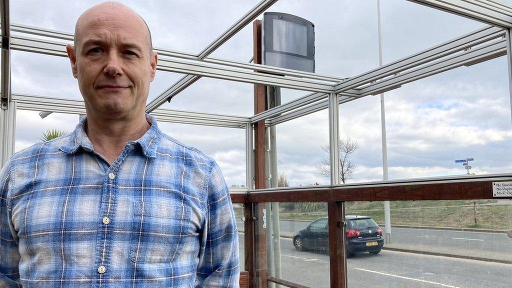 Paul Hooper, outside Hooper's café with his speed monitoring device the square grey box above