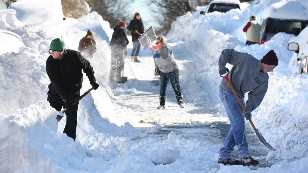 People clearing snow
