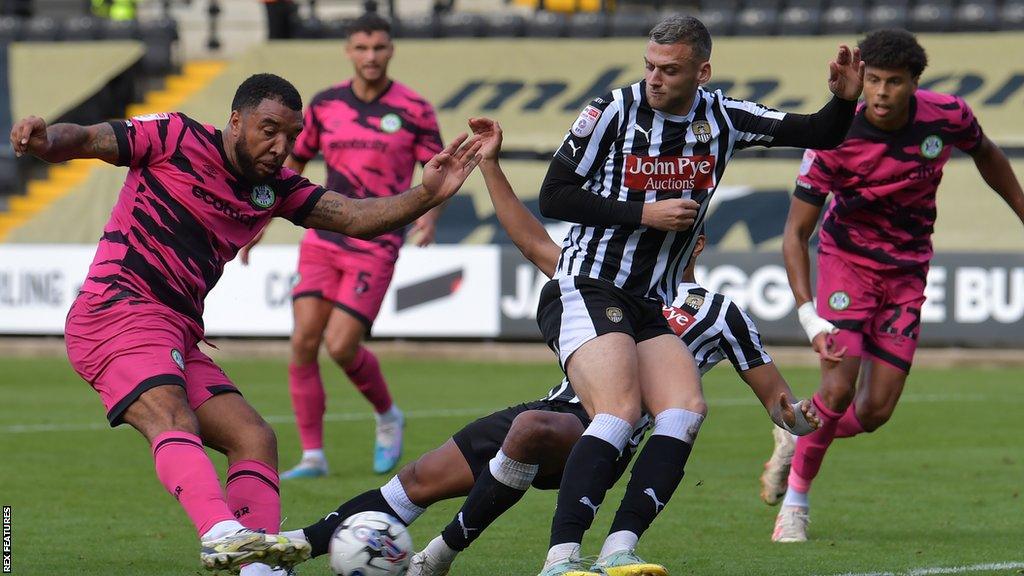 Troy Deeny (left) shoots the ball in the area for his second goal for Forest Green