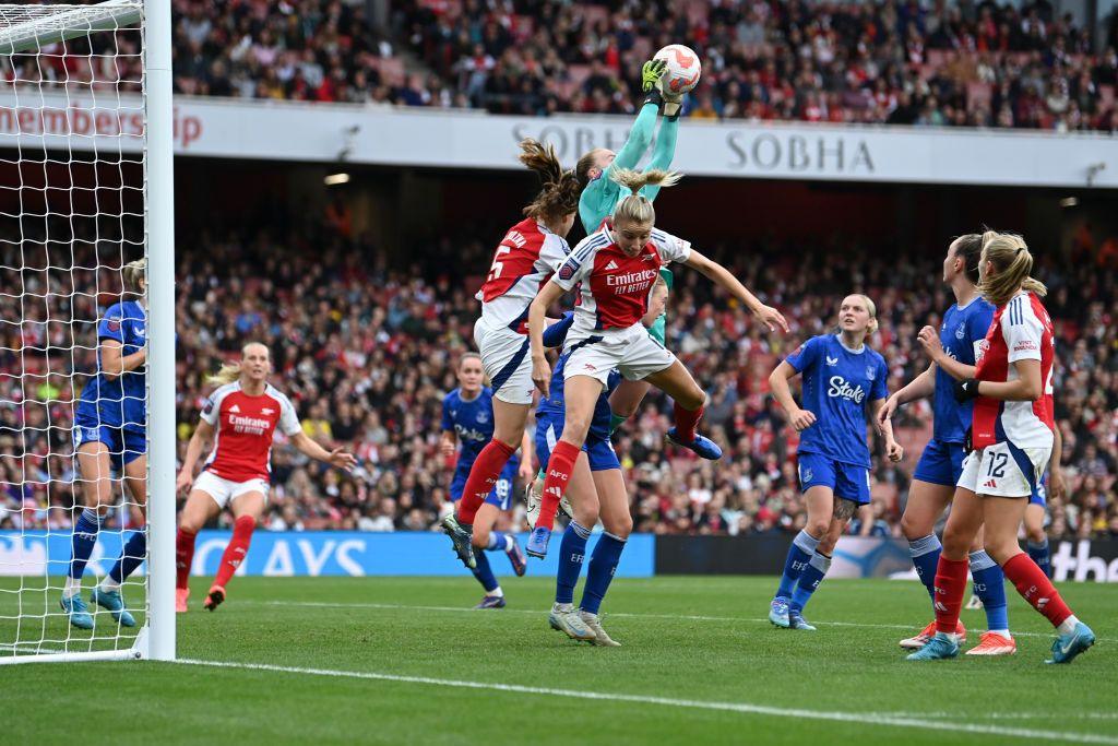 Courtney Brosnan jumps off the ground to catch the ball while playing for Everton against Arsenal