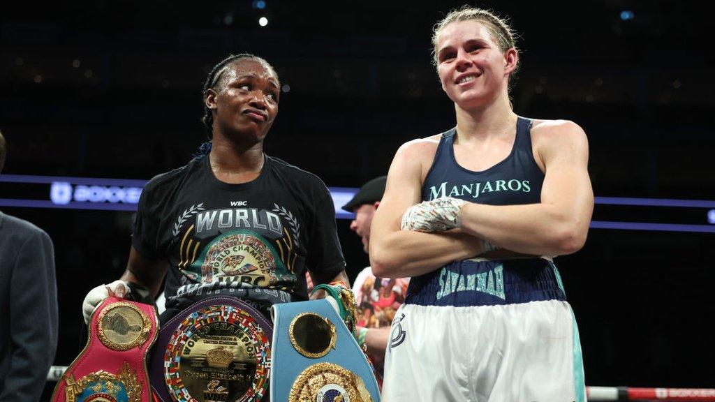 Claressa Shields looks at Savannah Marshall as they stand side by side after a fight