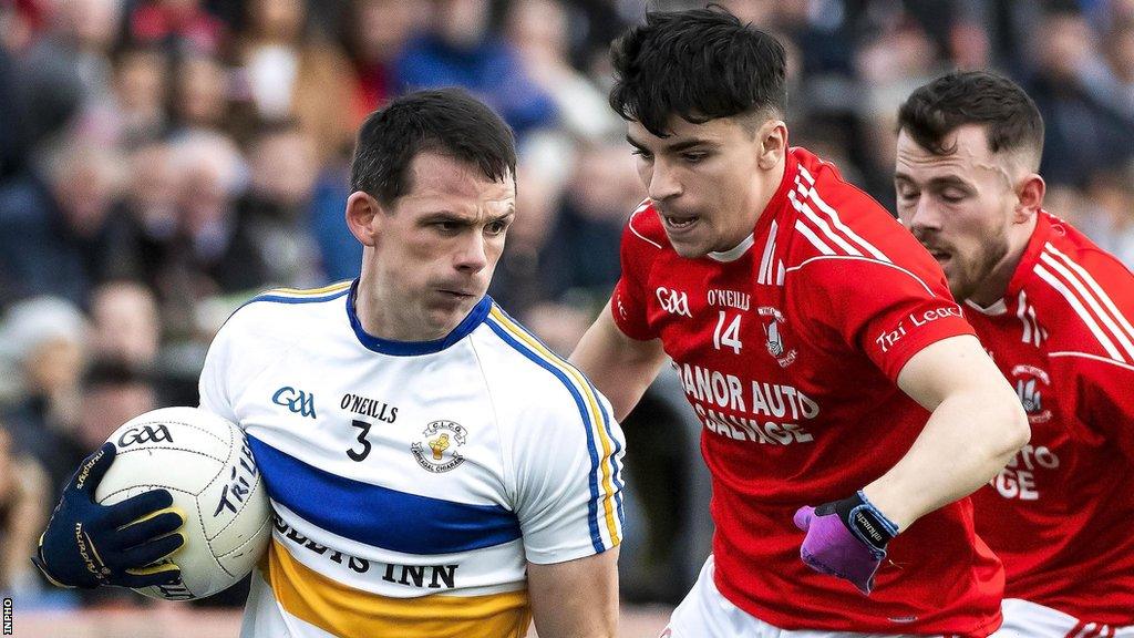 Trillick's Lee Brennan is about to get in a tackle on Errigal Ciaran's Aidan McCrory in the 2019 Tyrone Final