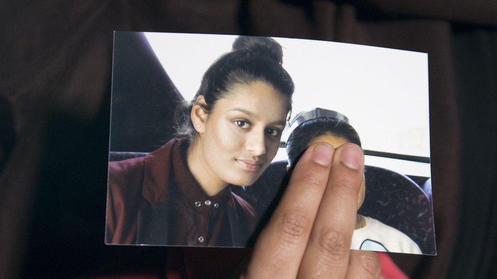 Shamima Begum's sister holds a photo of Shamima Begum in 2015