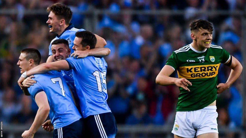 Dublin players celebrate winning in 2019 as David Clifford grimaces