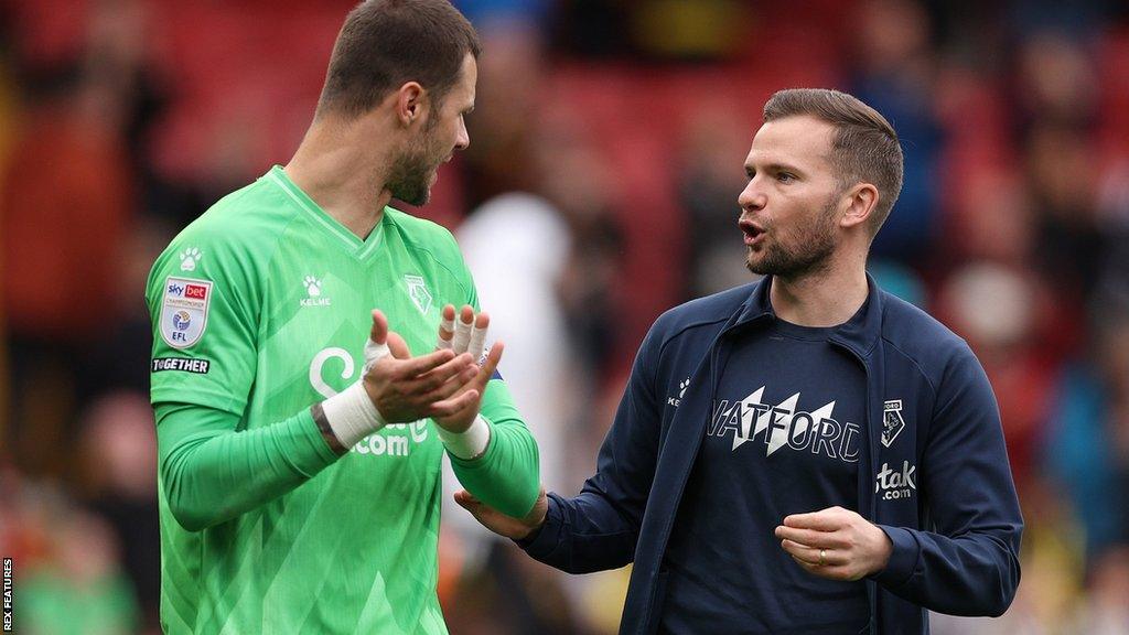 Interim Watford head coach Tom Cleverley (right) issues instructions to goalkeeper Daniel Bachmann