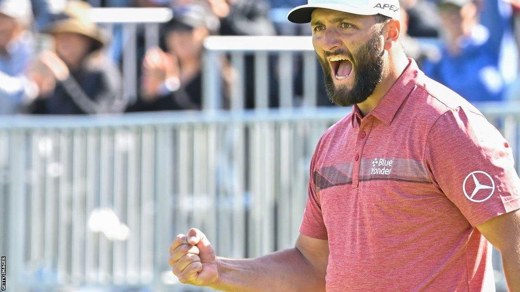 Jon Rahm reacts to holing a birdie putt on the 14th green at Riviera in Los Angeles