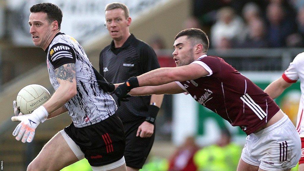 Niall Morgan attempts to burst away from Galways's Sean Mulkerrin at Healy Park