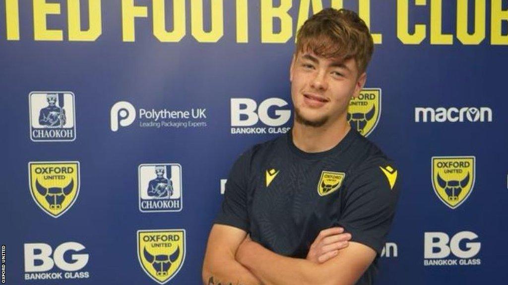 Striker Cameron Cooper poses in his training shirt at Oxford United's training facility.