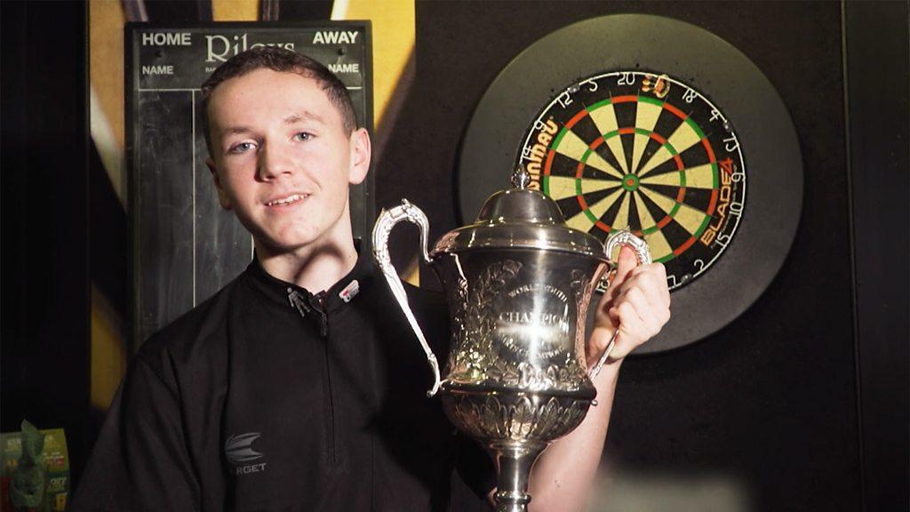 Darts player Leighton with his trophy.