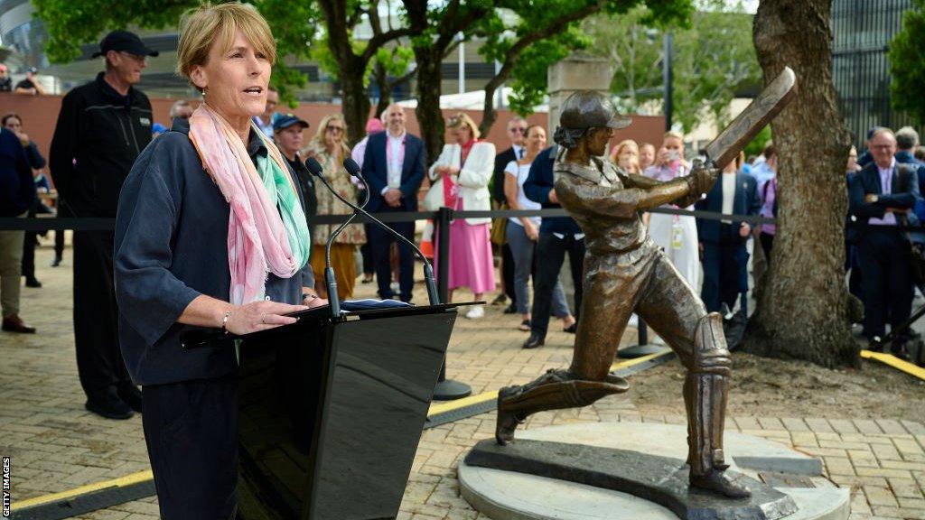 Belinda Clark next to her statue at the Sydney Cricket Ground