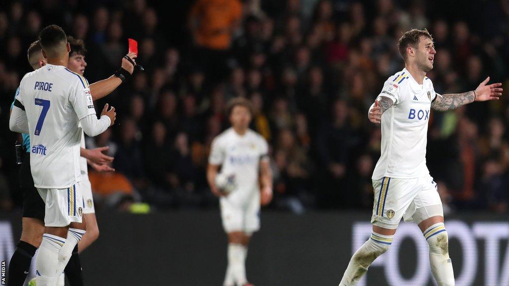 Leeds United centre-back Joe Rodon (far right) is sent off by referee Stephen Martin (left, obscured) during their match against Hull City