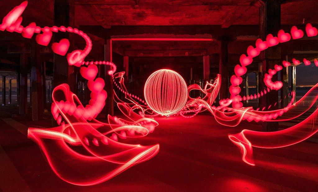 Valentine's Day light painting featuring red hearts under Walton Pier at low tide