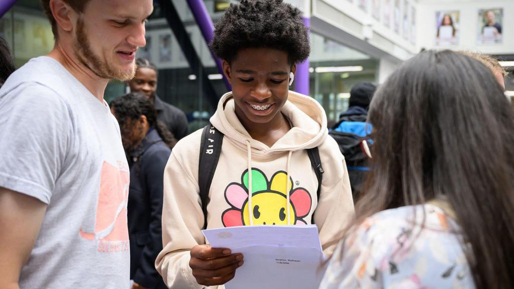 A student shares their grades after opening their GCSE results at the City of London Academy Southwark, a school sponsored by the City of London