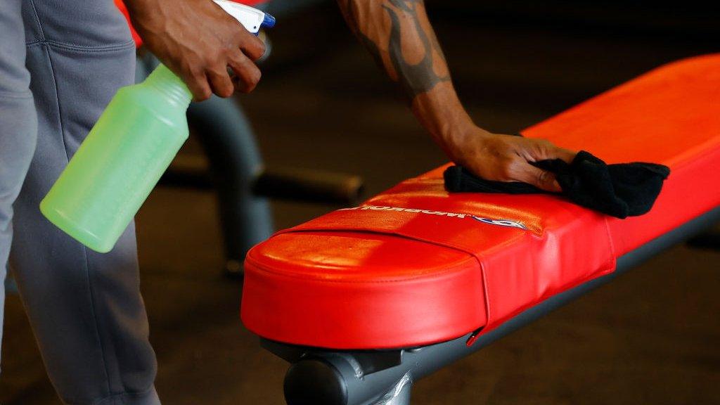 gym equipment being cleaned