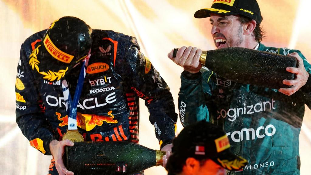 Max Verstappen and Fernando Alonso celebrate on the podium