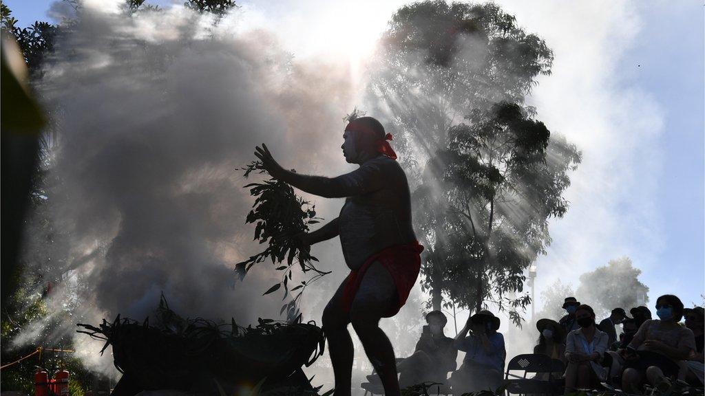 Indigenous performers hold a smoking ceremony as part of the WugulOra Morning Ceremony at Barangaroo Reserve