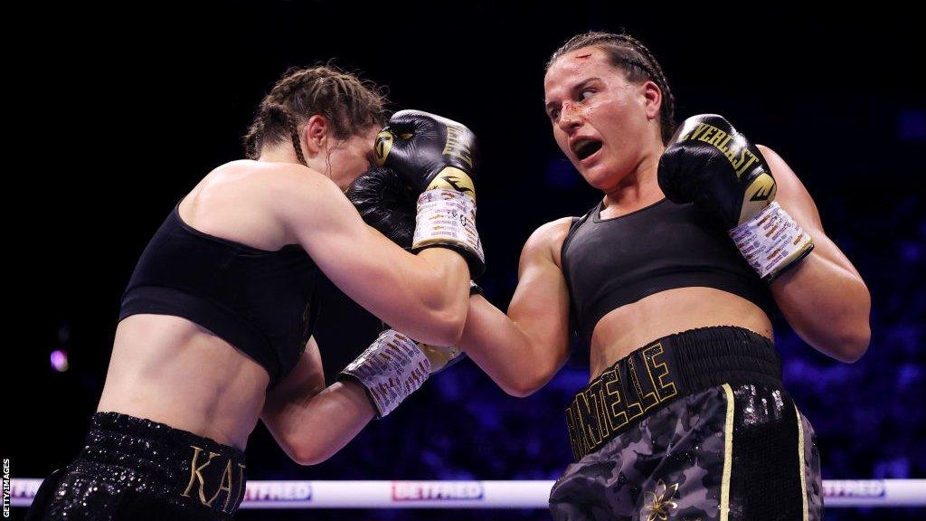 Chantelle Cameron throws an uppercut against Katie Taylor