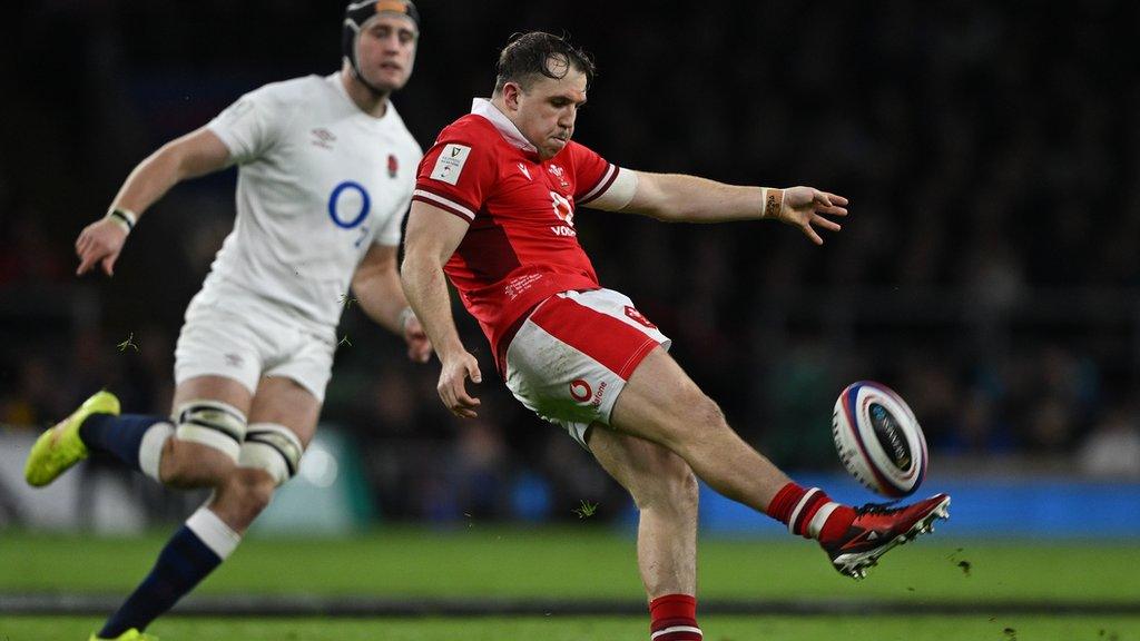 Wales Ioan Lloyd kicks against England