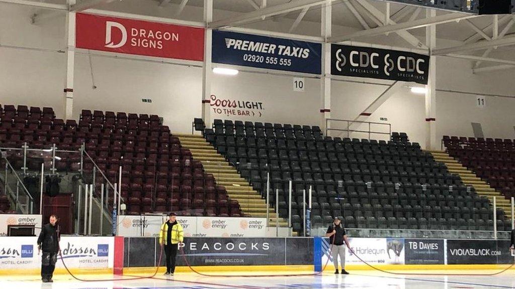 People resurfacing the ice rink at ice Arena Wales