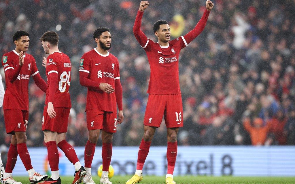 Liverpool players celebrate in front of the Kop