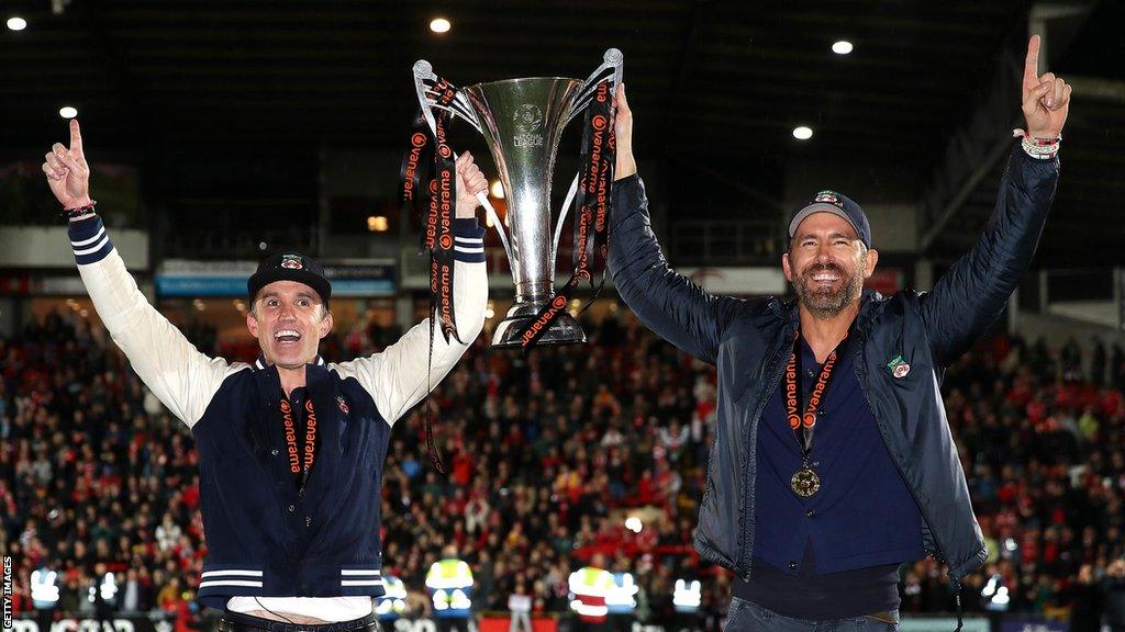 Wrexham's owners with the National League title trophy