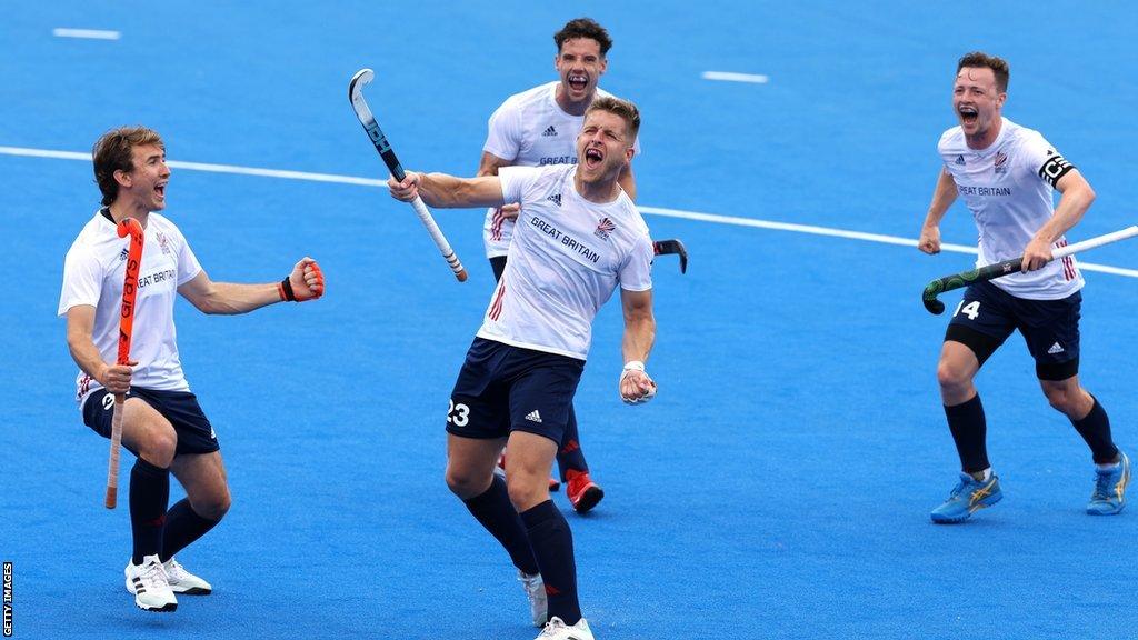 Nick Bandurak, surrounded by team-mates, celebrates scoring for Great Britain against Spain in a Pro League match in June 2023