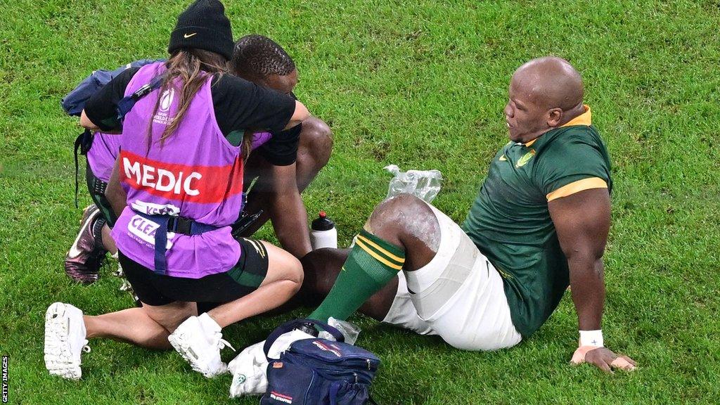 Bongi Mbonambi receives treatment from South Africa's medical team during the Rugby World Cup final