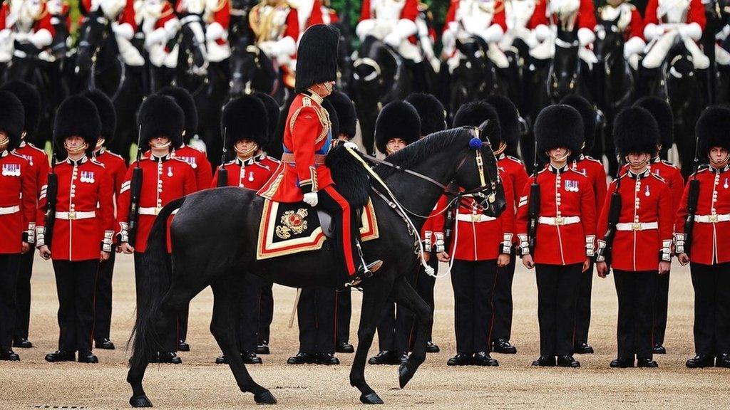 king charles inspecting soldiers during the trooping of the colour