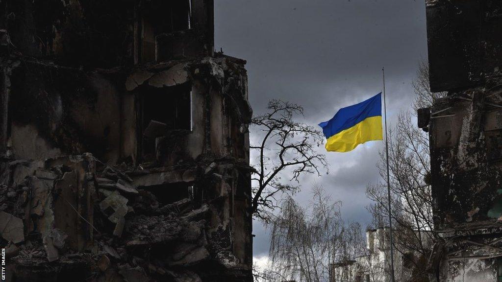 A Ukraine flag flutters between two bombed out buildings in Borodianka in April 2022