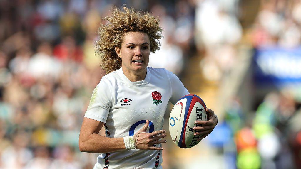 ellie kildunne running with a rugby ball.