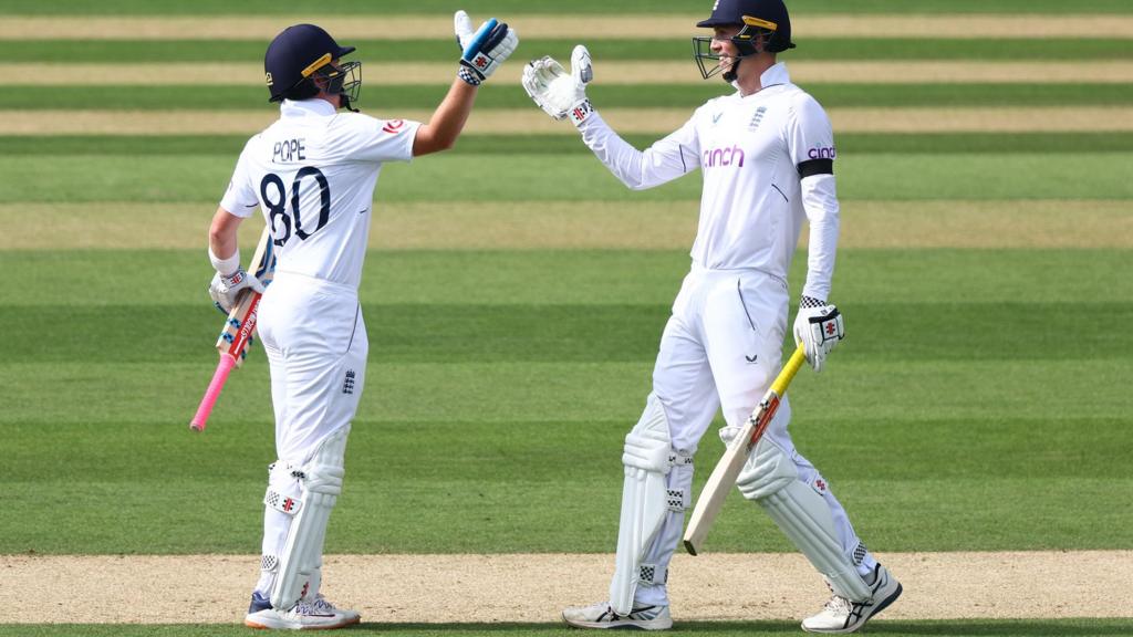 England batters Ollie Pope (left) and Zak Crawley (right) high five after beating South Africa