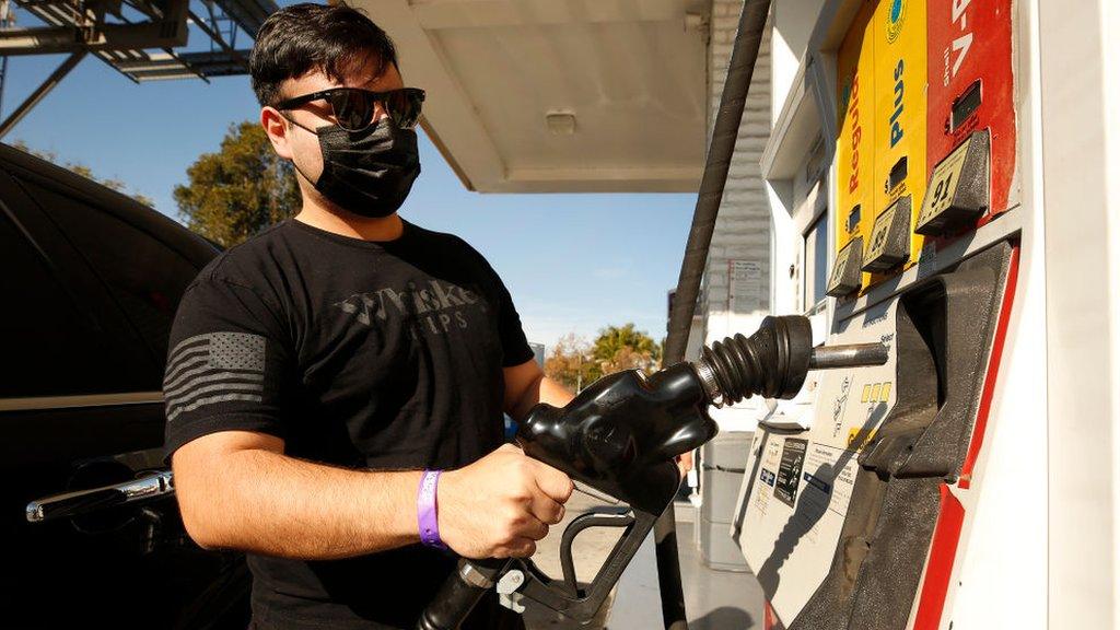 Man fills up his car with petrol at a Shell station in California.