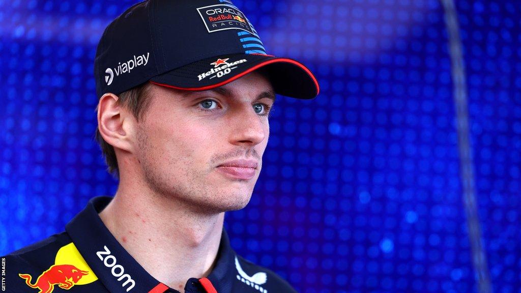 Red Bull driver Max Verstappen looks on from the paddock