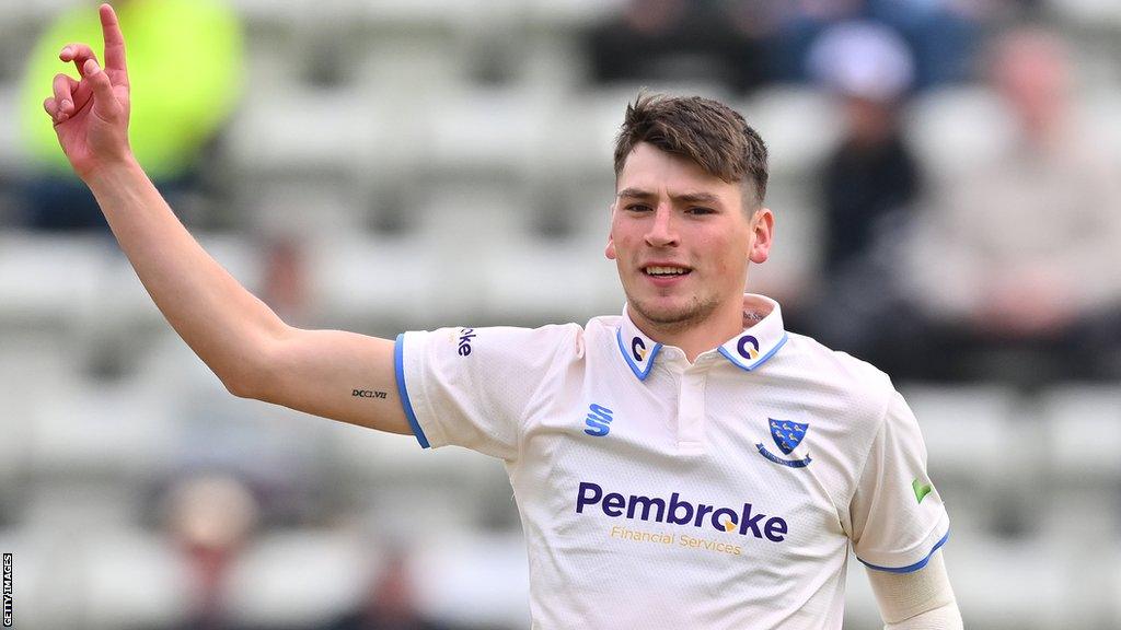 Sussex bowler Henry Crocombe celebrates taking a wicket