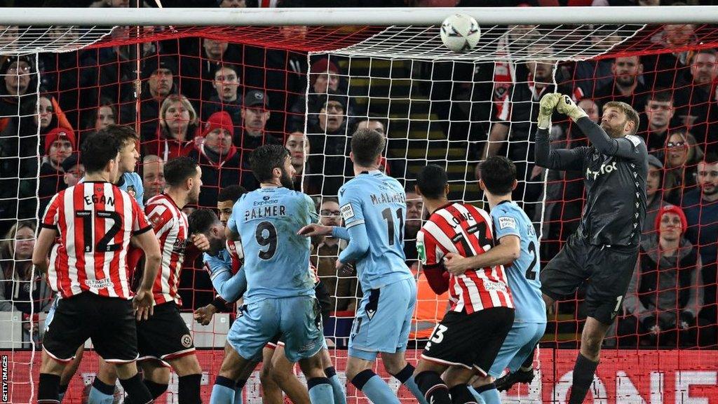 Rob Lainton punches away a cross during Wrexham's FA Cup fourth-round tie against Sheffield United