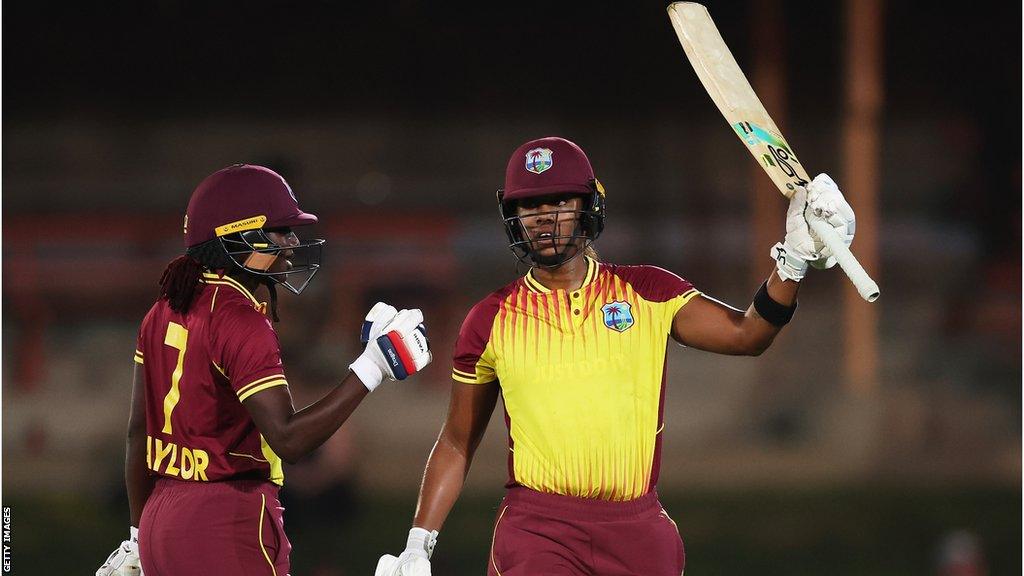 Stafanie Taylor (left) congratulates Hayley Matthews for reaching her 50 against Australia