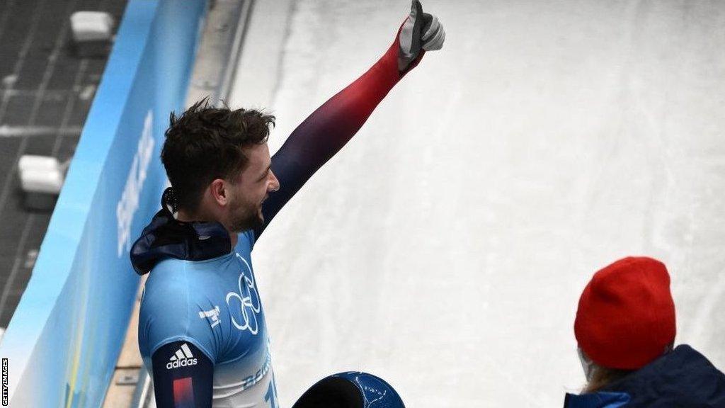 Marcus Wyatt gives a thumbs up after competing in the men's skeleton at the Beijing 2022 Winter Olympics