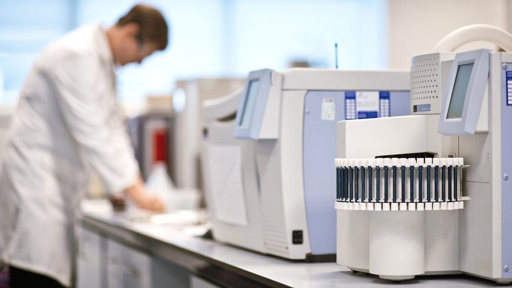 chemistry researcher using machines in a laboratory