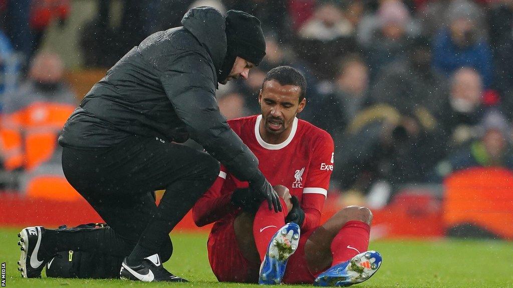 Joel Matip is treated for an injuury against Fulham