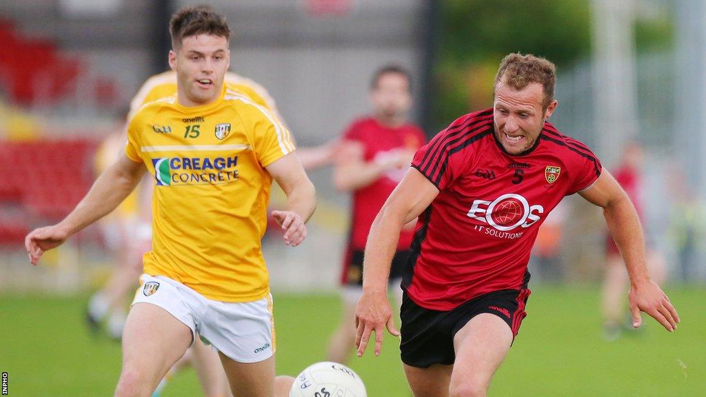 Patrick McBride battles Down's Darren O'Hagan for the ball in 2018